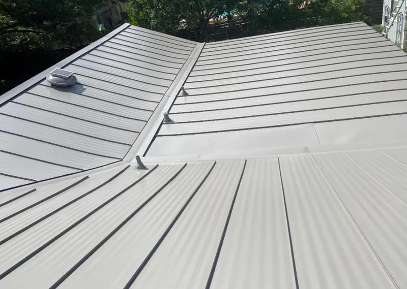 Solar attic fan installed on a metal roof for Roof Ventilation in Brooklyn